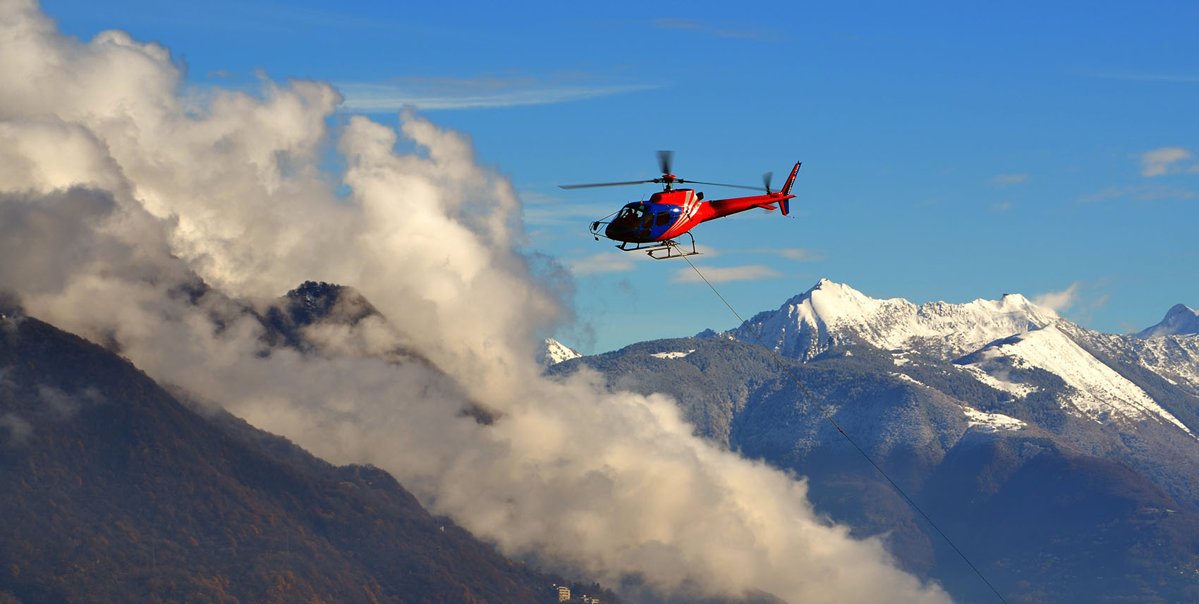 helicopter-flying-among-clouds-snow-capped-mountains-min_small Helicopter transfer from Milan and Geneva
